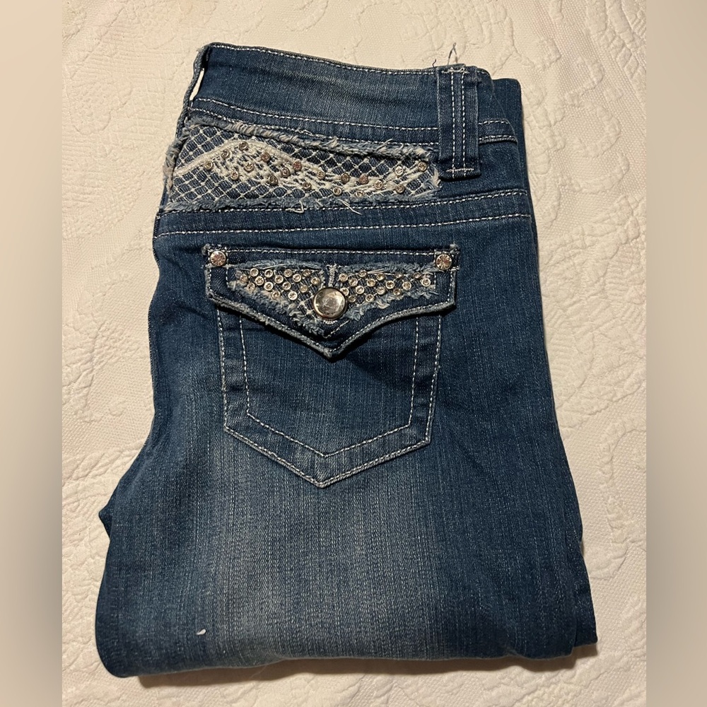 Blue Jeans with Decorative Embroidery and Distressed Texture